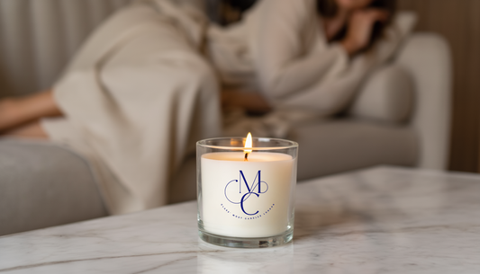 “Luxury soy candle glowing on a coffee table in a small London apartment