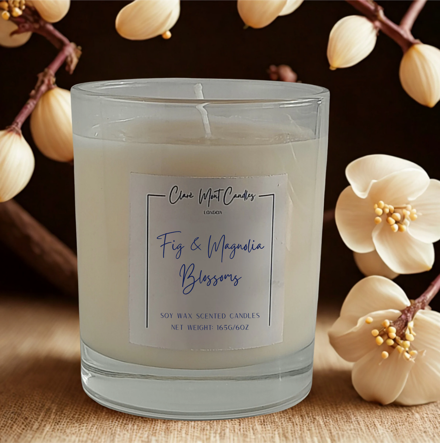 Scented candle labeled 'Fig & Magnolia Blossoms' with floral elements in the background