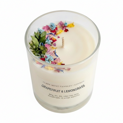 Grapefruit & Lemongrass hand poured Clare' Mont candle with floral and greenery elements on a white background