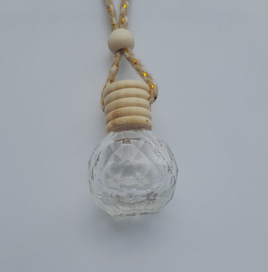 Clear glass pendant with wooden beads on a white background