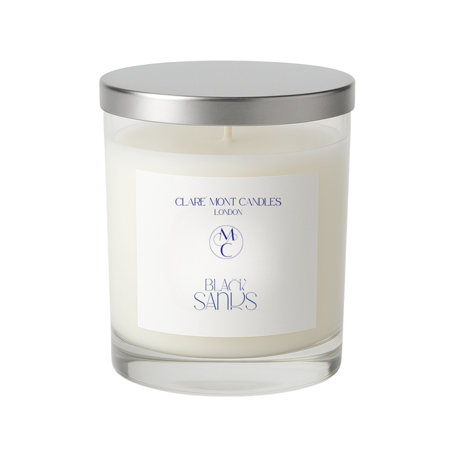 Candle with a silver lid and 'Claremont Candles London' label on a white background
