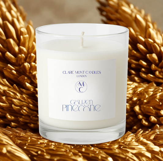 Candle with a label on a decorative background of gold pinecones