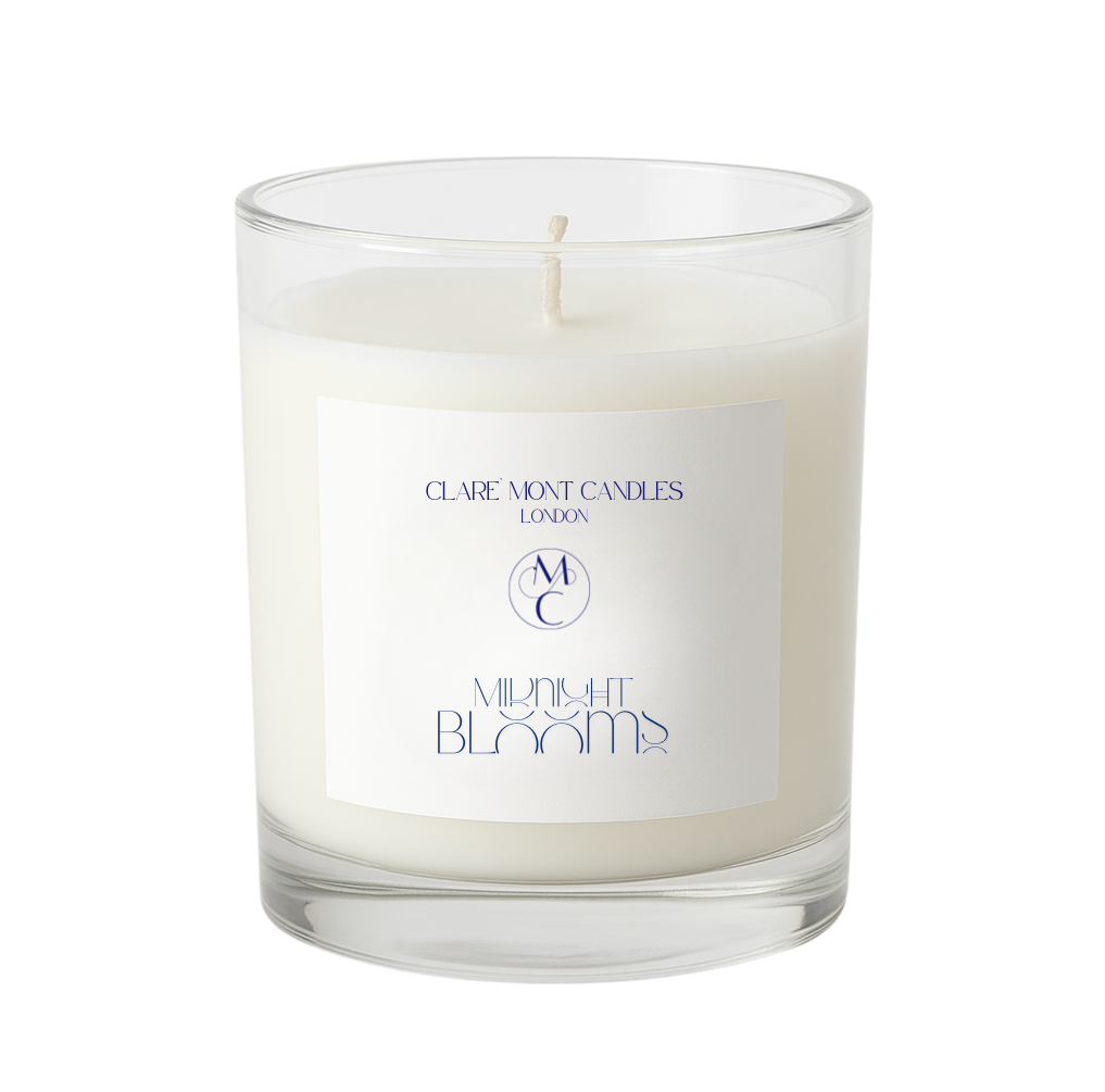 Candle in a clear glass jar with a label on a white background