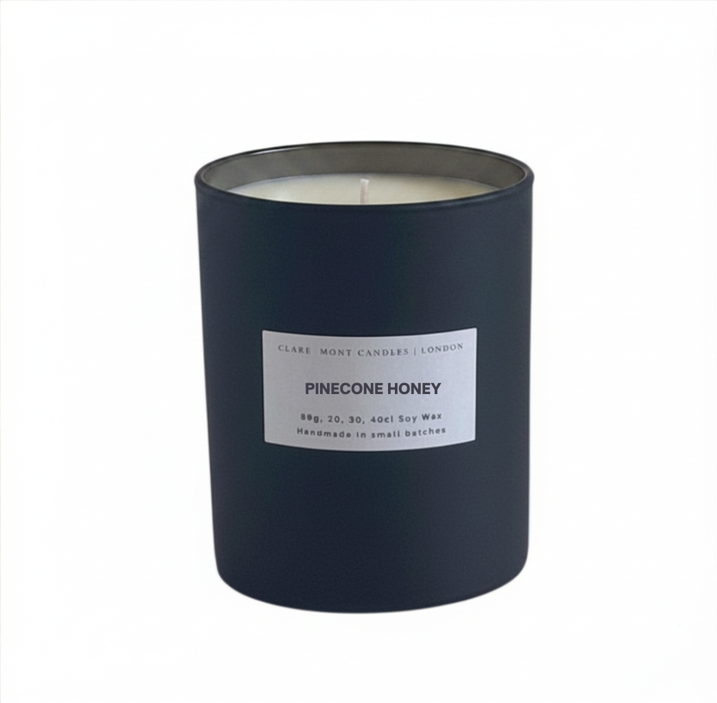 Pinecone Honey candle with a white label on a white background. Made by Clare` Mont Candles