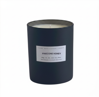Pinecone Honey candle with a white label on a white background. Made by Clare` Mont Candles